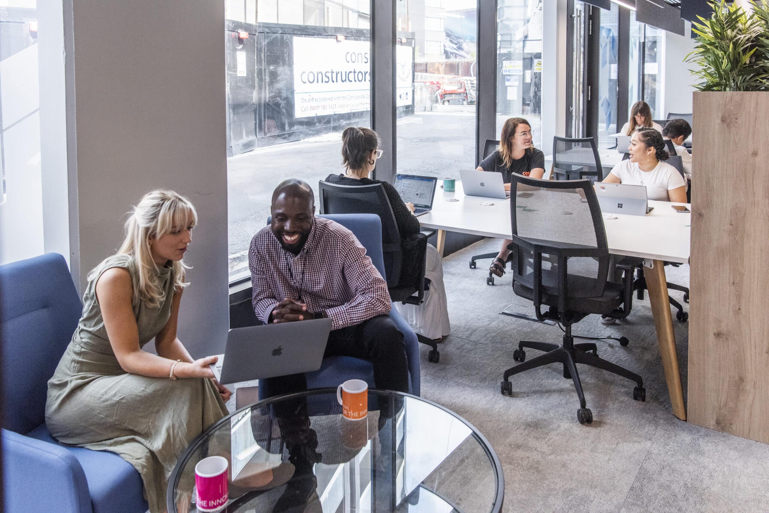 Group working Plexal Shoreditch hotdesking and fixed desks